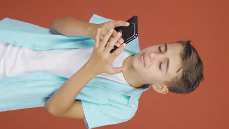 Vertical-video-of-Boy-getting-bad-news-on-the-phone-gets-upset.